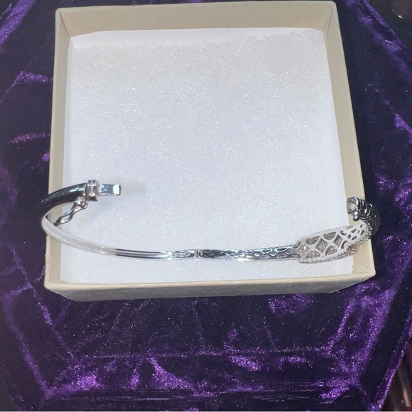 STERLING SILVER BRACELET WITH 14 KARAT GOLD TRIM.